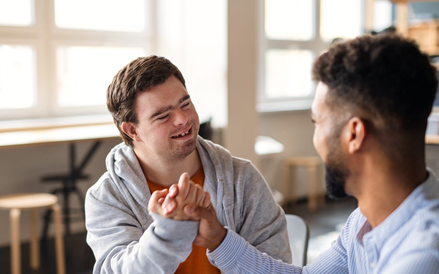 A young man and a support worker talking together